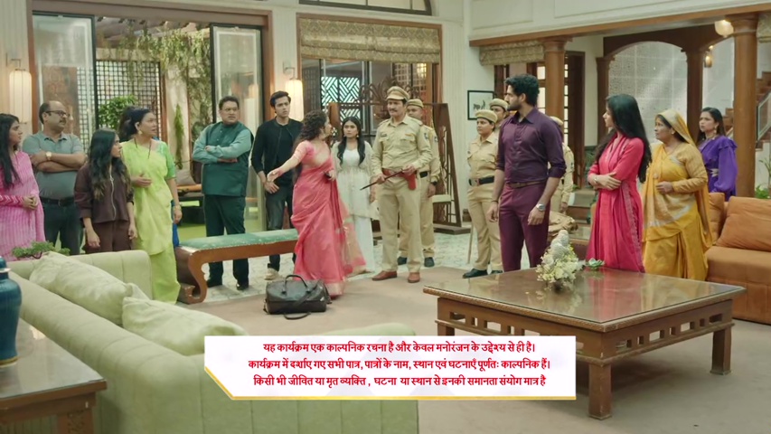 Anisha pleading with Vijay as the police stand nearby