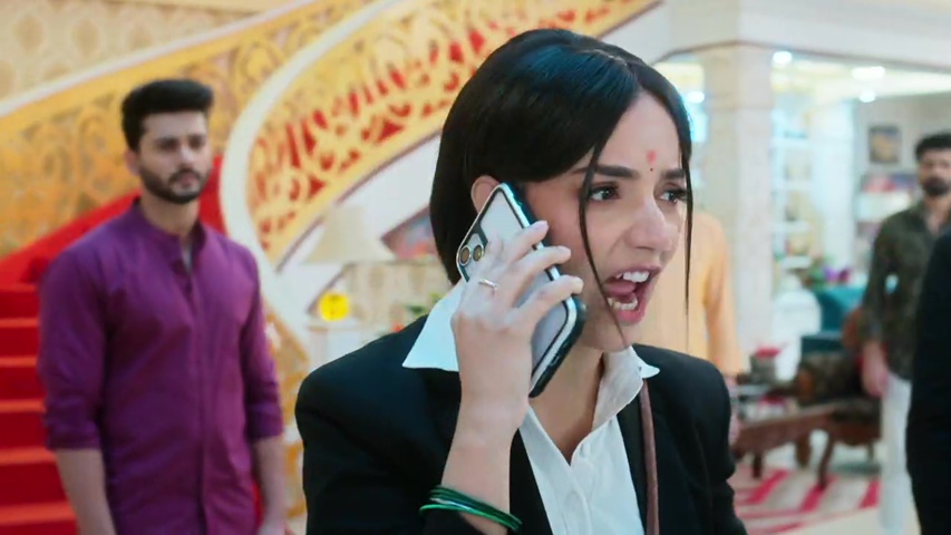 Anjali standing up to Chandraman over the phone, showing her fearless expression