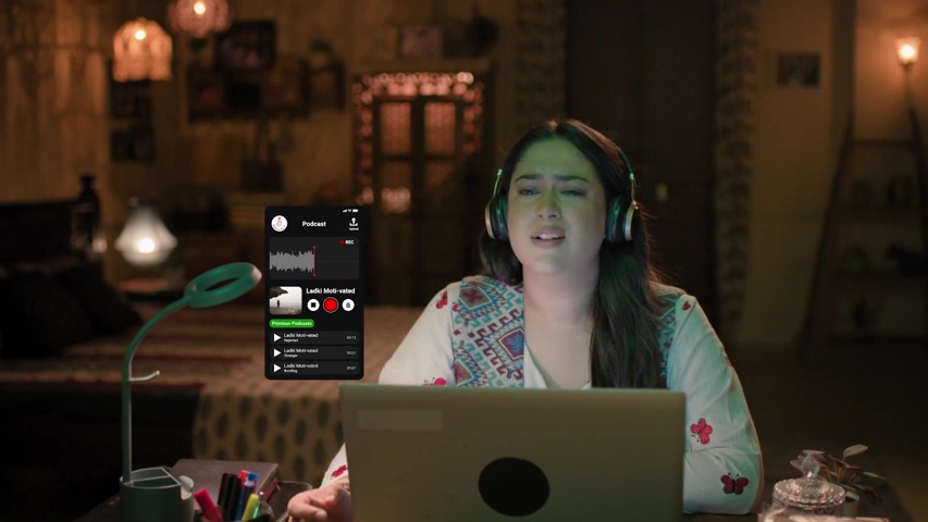 Bhavya recording her podcast with a thoughtful expression