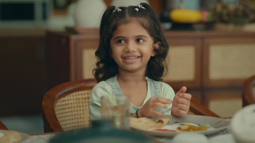 Dhwani playfully refusing to listen to Rani and Digvijay at the dinner table, with everyone smiling