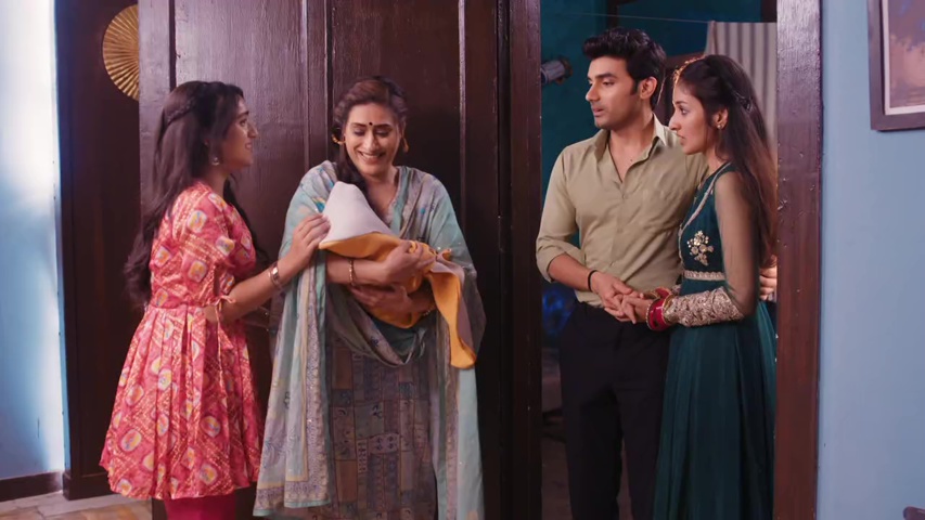 Gurpreet holding the baby with a joyful smile