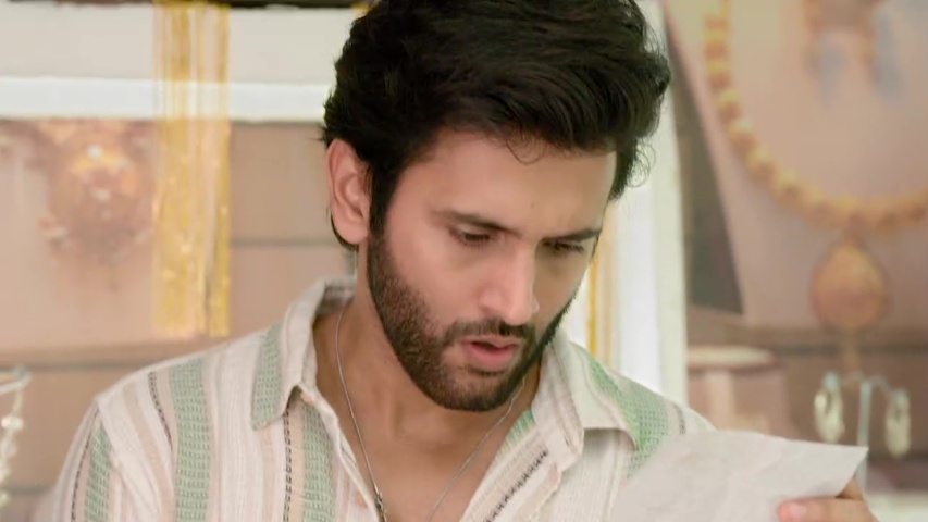 Isha and Om at KL Jewellers, looking at the receipt with Dilip Kaka’s name