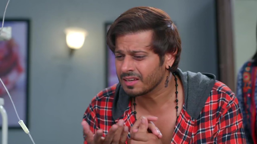 Kabir crying beside his mother’s hospital bed