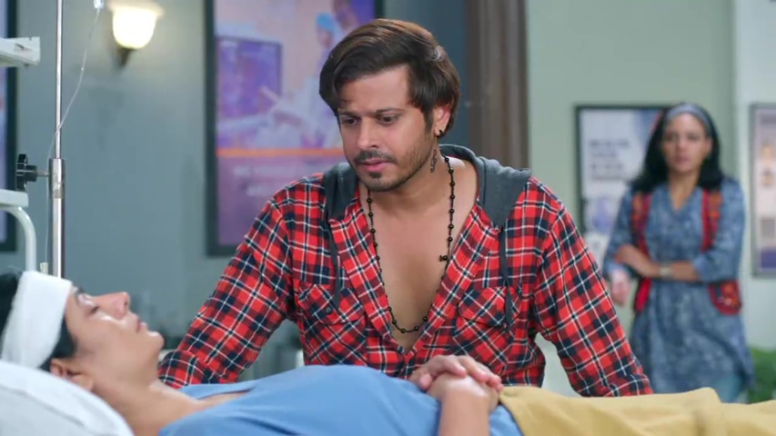 Kabir sitting worriedly beside his mother’s hospital bed