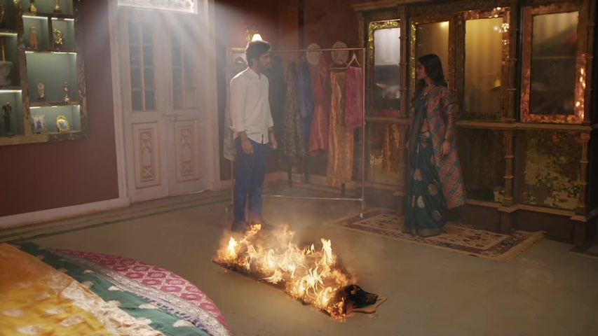 Maan burning Rajnandini’s dress, with flames reflecting his anger