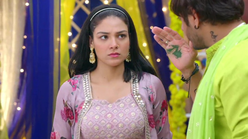 Megha and Kabir sharing a light moment as he holds her hand, with mehndi smeared between them