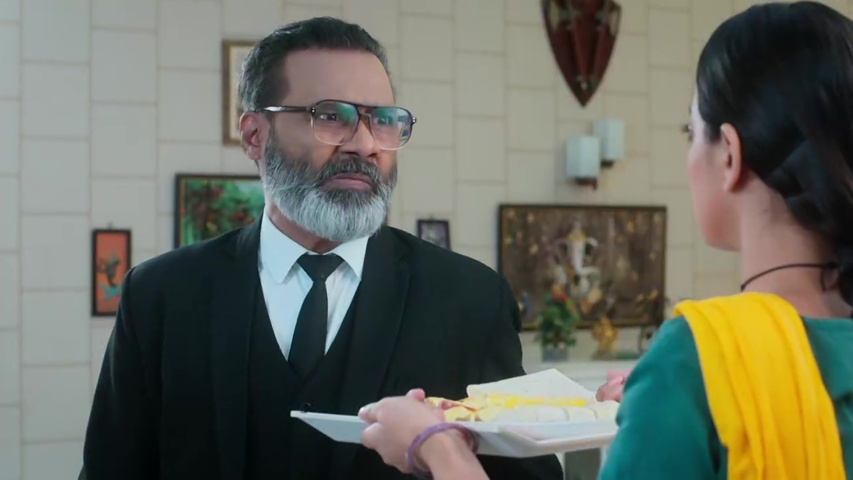 Raghav angrily knocking the plate from Padma’s hands, with Rupa Rani standing at the door