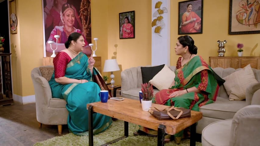 Renuka and Shakuntala discussing their dance class plan, looking determined