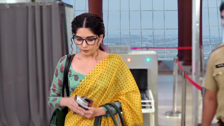 Savi at the airport security check, looking worried