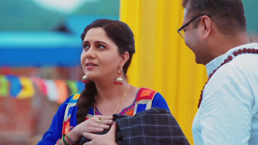 Sharda holding Preet, smiling as Ashok and the priest discuss the miracle