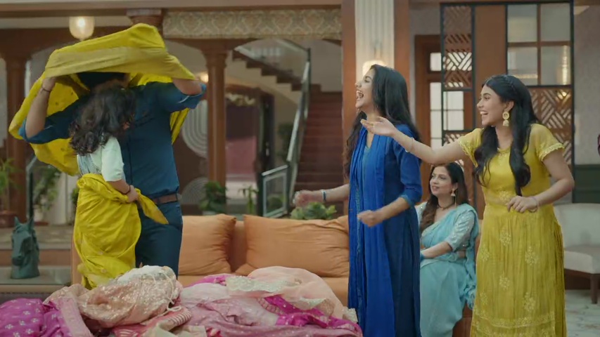 family moment with Rani, Digvijay, and Dhwani laughing as they try on sarees