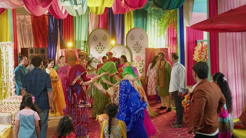 fun moment from the game with women in colorful traditional dresses